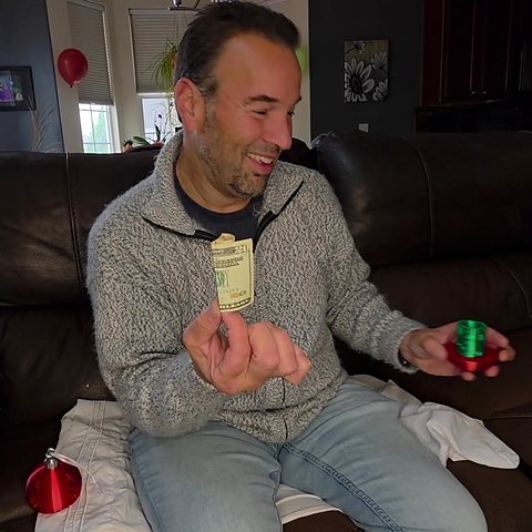Enrique laughing with the cash in his hand.