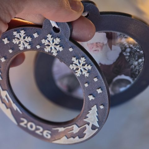 The front ring lifted off the ornament, with the photo still seated in the back.